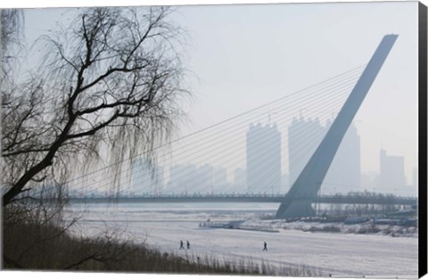 Framed Songhuajiang Highway Bridge over the frozen Songhua River with buildings in the background, Harbin, Heilungkiang Province, China Print