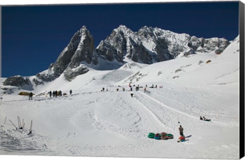 Framed People enjoying snow tubing at Jade Dragon Snow Mountain, Lijiang, Yunnan Province, China Print