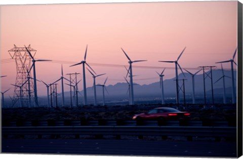 Framed Car moving on a road with wind turbines in background at dusk, Palm Springs, Riverside County, California, USA Print