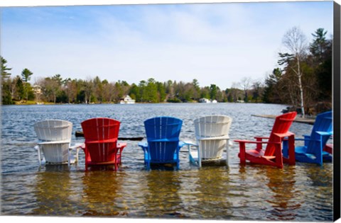 Framed Adirondack chairs partially submerged in the Lake Muskoka, Ontario, Canada Print