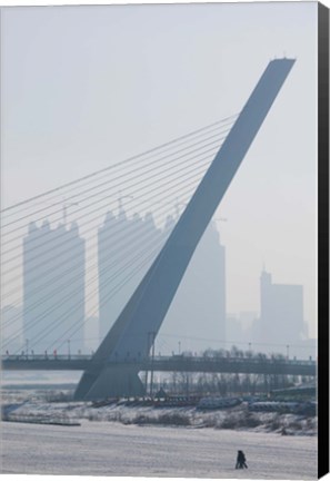 Framed Songhuajiang Highway Bridge across the frozen Songhua River with buildings in the background, Harbin, China Print