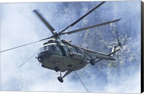 Framed Bulgarian Air Force Mi-17 helicopter over a forest fire in Bulgaria Print