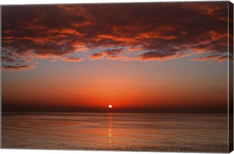 Framed layer of clouds is lit by the rising sun over Rio de la Plata, Buenos Aires, Argentina Print