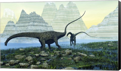 Framed Diplodocus dinosaurs munch on vegetation near a mountain lake Print