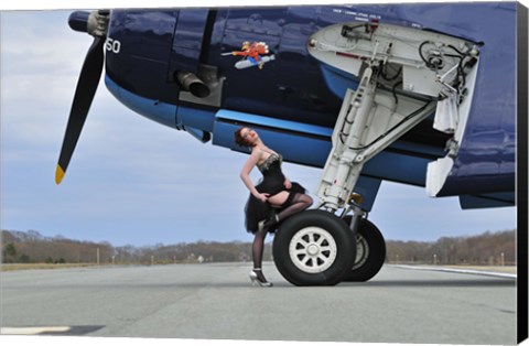 Framed 1940&#39;s style pin-up girl resting on the wheel of a TBM Avenger Print