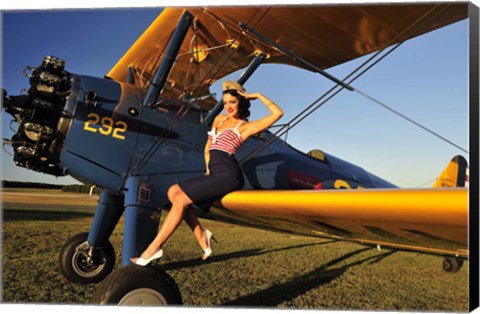 Framed 1940&#39;s style pin-up girl sitting on the wing of a Stearman biplane Print