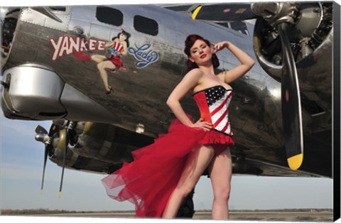 Framed Beautiful 1940&#39;s style pin-up girl standing under a B-17 bomber Print