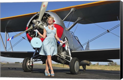 Framed Elegant 1940&#39;s style pin-up girl standing in front of an F3F biplane Print