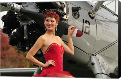 Framed Redhead pin-up girl in 1940&#39;s style dancer attire holding on to a vintage aircraft propeller Print