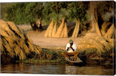 Framed Local Man Fishing and Piles of Straw for Hatch, Okavango Delta, Botswana Print