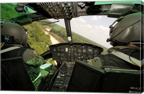 Framed Two instructor pilots practice low flying operations in a UH-1H Huey helicopter Print