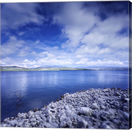 Framed Tranquil lake and rocky shore against cloudy sky, Sardinia, Italy Print