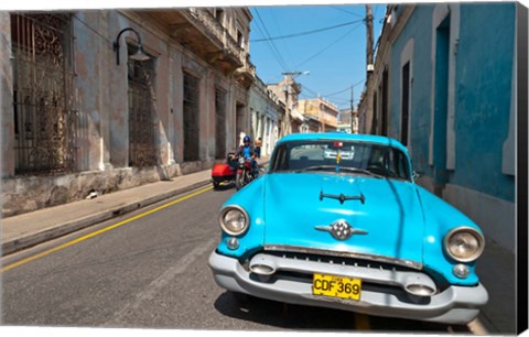 Framed Cuba, Camaquey, Oldsmobile car and buildings Print