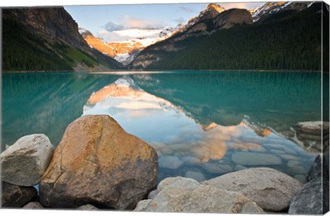 Framed Rocky Mountains and boulders reflected in Lake Louise, Banff National Park, Alberta, Canada Print