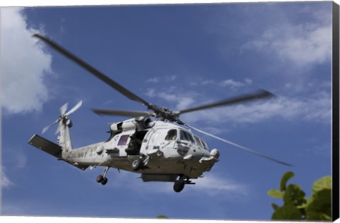 Framed Crew Chief looks out the side door of a helicopter in flight Print