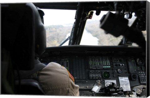 Framed UH-60 Blackhawk flies the River to an Unknown Village to Drop off a Care Package Print