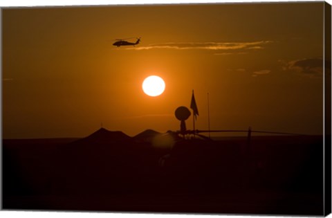 Framed UH-60 Blackhawk Flies Over Camp Speicher Airfield at Sunset Print