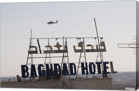 Framed AH-64 Apache in flight over the Baghdad Hotel in central Baghdad, Iraq Print