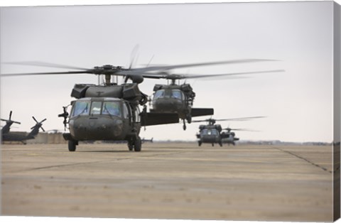 Framed UH-60 Black Hawks taxis out for a mission over northern Iraq Print