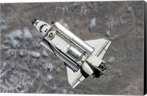 Framed Aerial view of Space Shuttle Discovery over Earth as it approaches the International Space Station Print