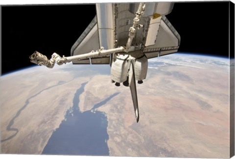 Framed Aft Section of the Docked Space Shuttle Discovery and the Station&#39;s Robotic Canadarm2 Print