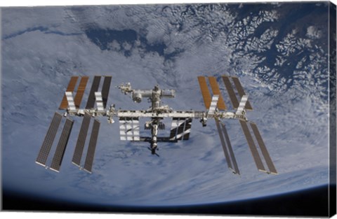 Framed International Space Station set against the background of a cloud covered Earth Print