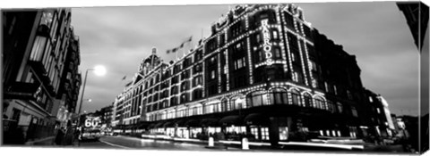 Framed Low angle view of buildings lit up at night, Harrods, London, England BW Print