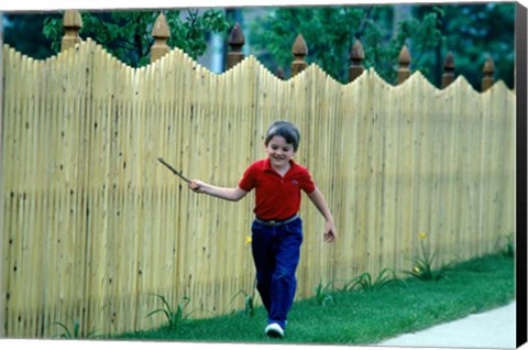 Framed 1980s Smiling Boy Running Along Sidewalk Print