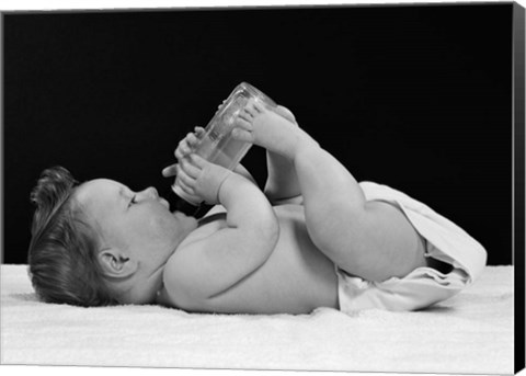 Framed 1950s Baby Lying On Back Drinking From Bottle Print