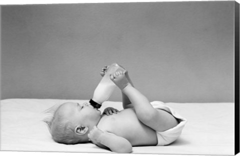 Framed 1940s Baby Prone Drinking From Milk Bottle Print