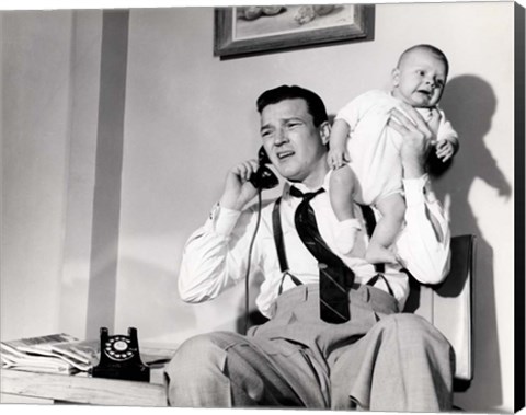 Framed 1950s Father Holding Baby While On The Phone Print