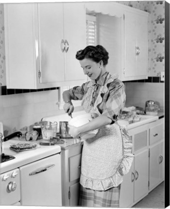 Framed 1950s Housewife In Kitchen Mixing Ingredients Print