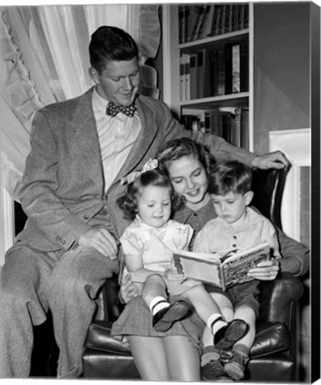 Framed 1940s Father Watching  Mother Reading To Son And Daughter Print