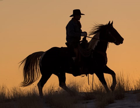 Framed Cowboy Riding His Horse Winters Snow Silhouetted At Sunset Print