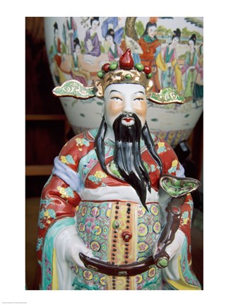 Framed Statue of a snake charmer holding a snake Print