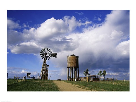 Framed Low angle view of a water tower and an industrial windmill, 1880 Town, South Dakota, USA Print