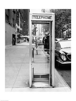 Framed Car parked at the side of a road near a telephone booth Print