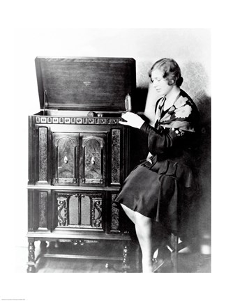 Framed Young woman sitting beside an RCA Radio-Phonograph and Home Recorder Print