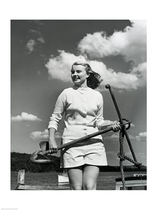 Framed Young woman standing on boat, holding anchor Print