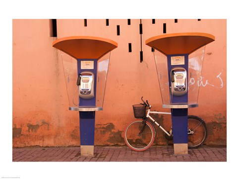 Framed Public telephone booths in front of a wall, Morocco Print