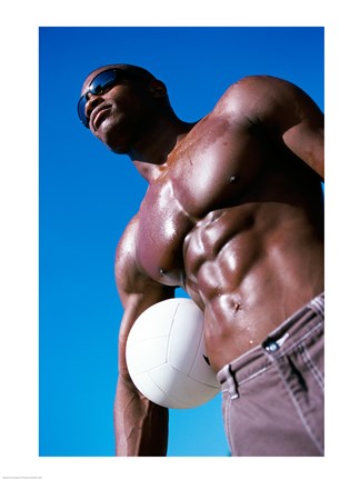 Framed Low angle view of a young man holding a volleyball Print