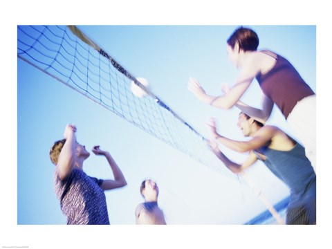 Framed Low angle view of two young couples playing beach volleyball Print