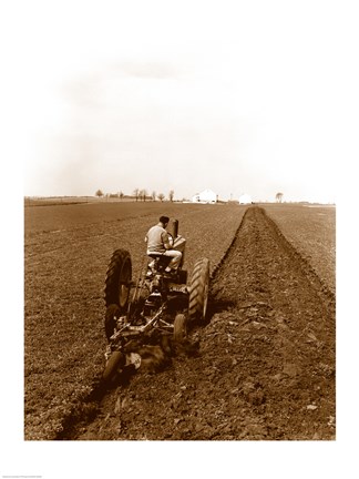 Framed USA, Pennsylvania, Farmer on Tractor Plowing Field Print