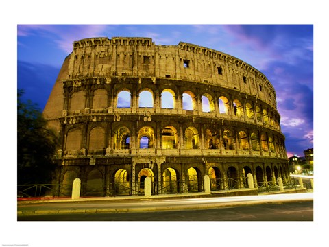 Framed Low angle view of the old ruins of an amphitheater lit up at dusk, Colosseum, Rome, Italy Print