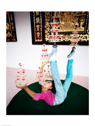 Framed Acrobat balancing glasses, Shanghai, China Print