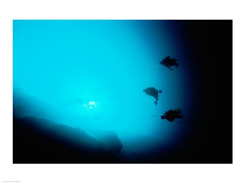 Framed Three scuba divers swimming underwater, Blue Hole, Belize Print