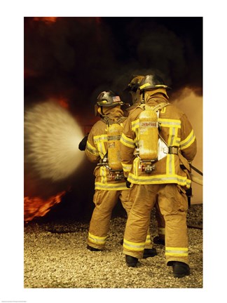 Framed Rear view of three firefighters extinguishing a fire Print