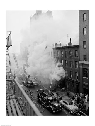 Framed New York City, Fire on East 47th Street, with fire engines shooting water on burning building Print