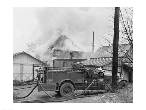 Framed Fire engine next to home in fire Print