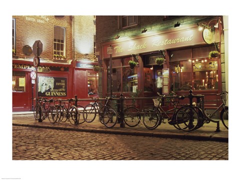Framed Bicycles parked in front of a restaurant at night, Dublin, Ireland Print